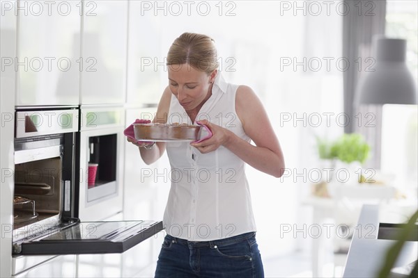 Woman smelling freshly baked cake