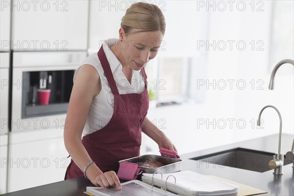 Woman checking recipe