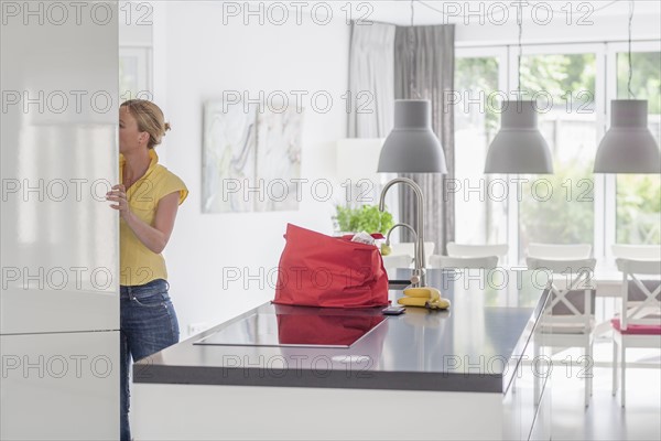 Woman unpacking groceries from shopping bag