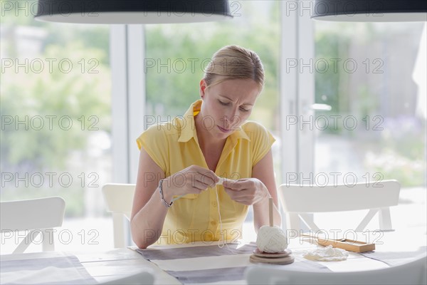 Woman embroidering at home