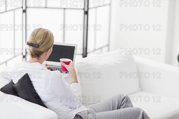 Woman using laptop in living room