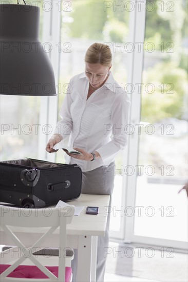 Woman packing suitcase for business travel