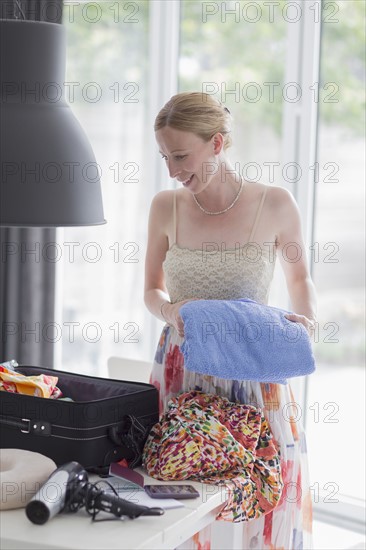 Woman packing suitcase