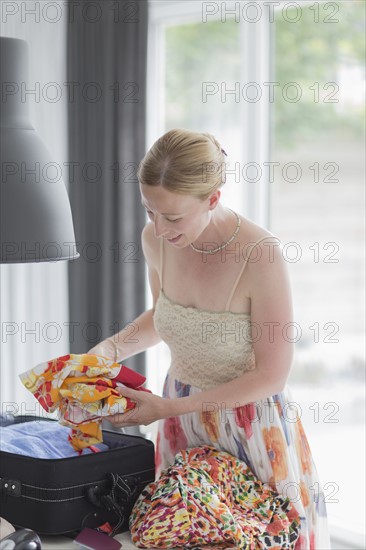 Woman packing suitcase