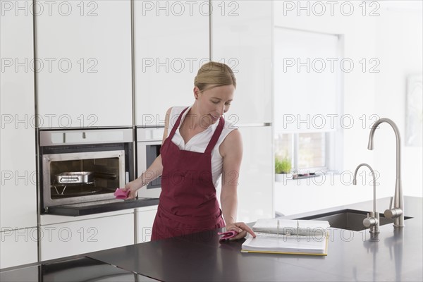 Mature woman preparing food in modern kitchen