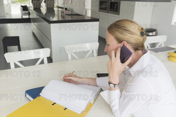 Mature woman working at table