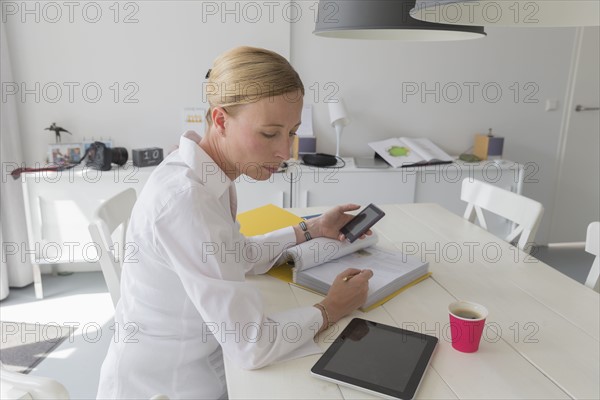 Mature woman working at table