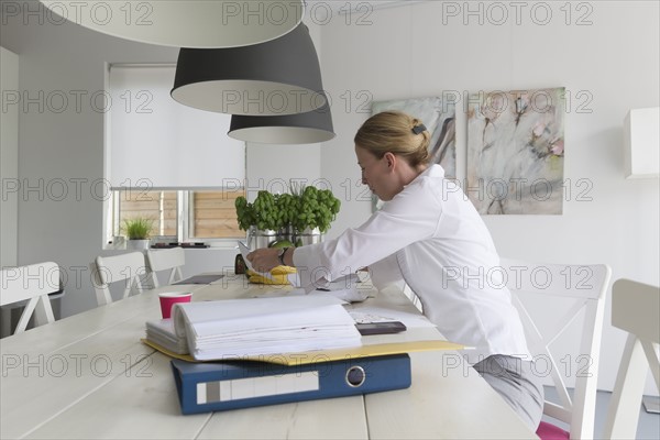 Mature woman working at table