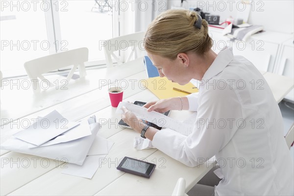 Mature woman working at table