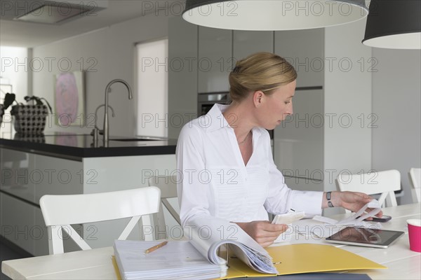 Mature woman working at table