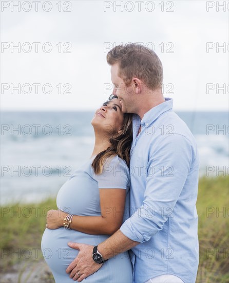 Pregnant couple embracing