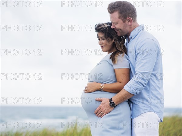 Pregnant couple embracing