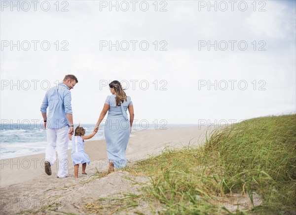 Family holding hands on beach