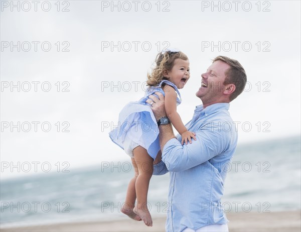 Father holding daughter