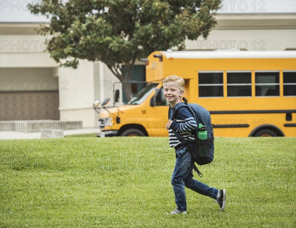 Boy with backpack at school