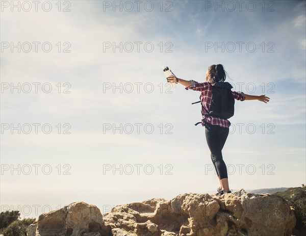 Woman on hike with arms outstretched