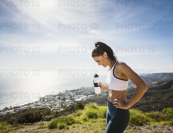 Woman in sportswear with water bottle