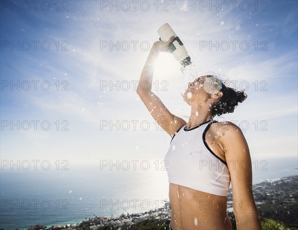 Woman pouring water on her head