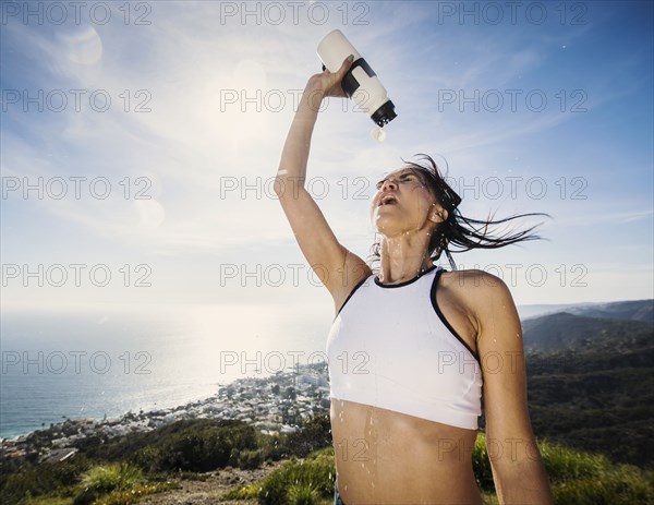 Woman pouring water on her head