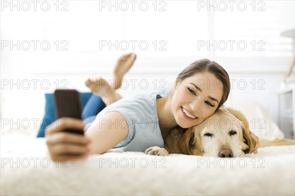 Woman taking selfie with dog