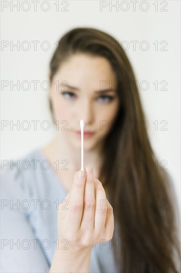 Woman holding cotton bud