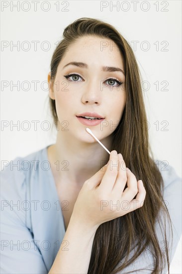 Woman holding cotton bud