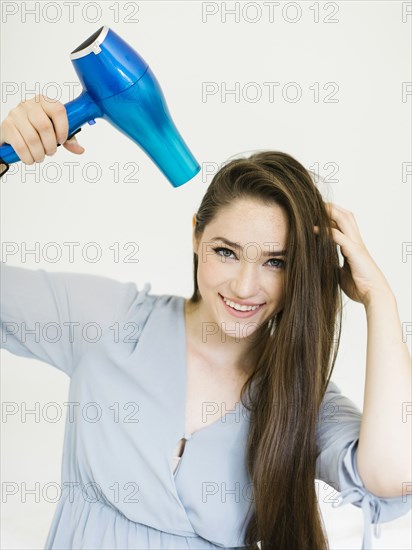 Woman using hair dryer