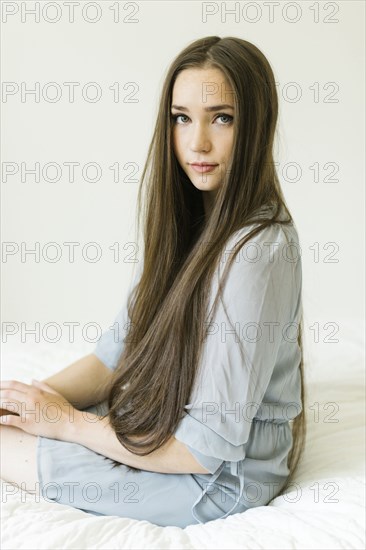 Portrait of young woman with long brown hair