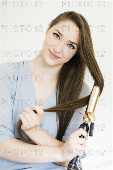 Woman using curling iron