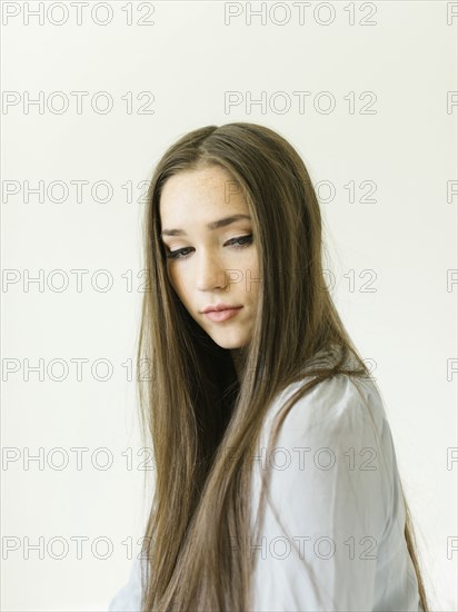 Portrait of young woman with long brown hair
