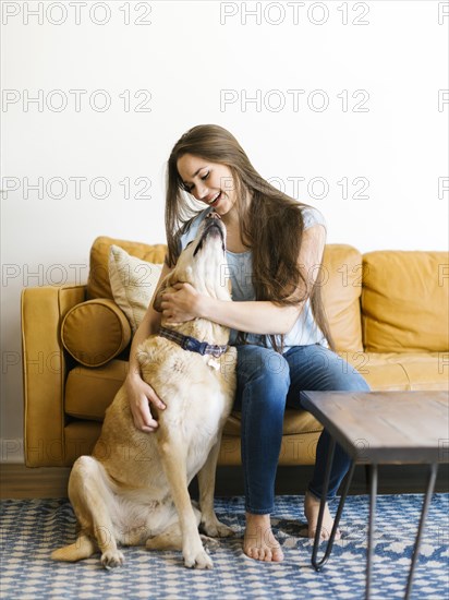 Woman on sofa with dog