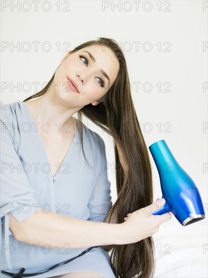 Woman using hair dryer