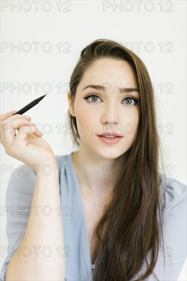 Woman applying eyeliner