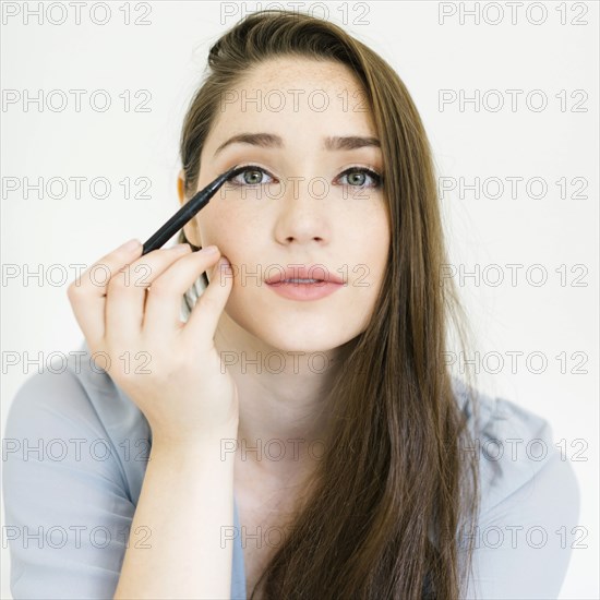 Woman applying eyeliner