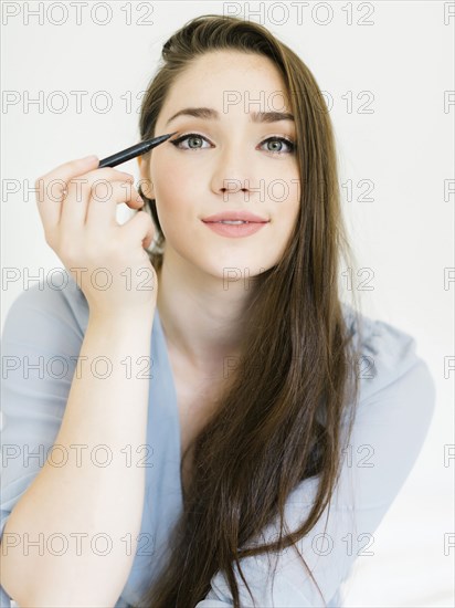 Woman applying eyeliner