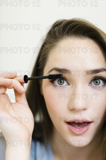 Woman applying mascara