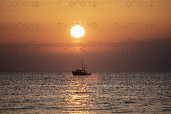 Fishing boat at sunset