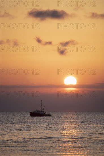 Fishing boat at sunset