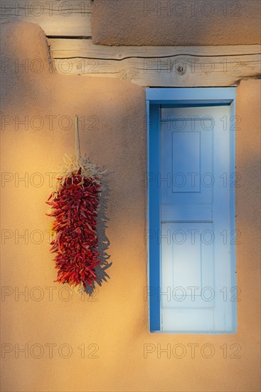 Red chilis on adobe wall