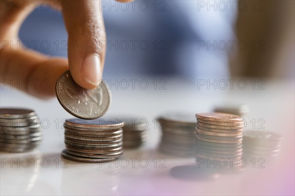 Hand of woman stacking coins