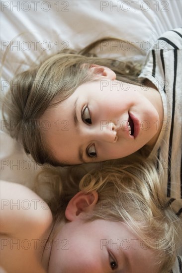 High angle of children lying on bed