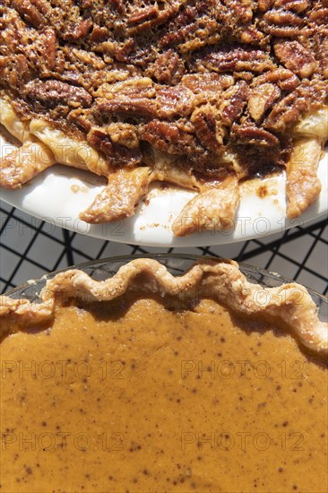 Pumpkin and pecan pies on a cooling rack