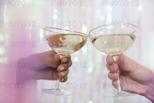 Hands of women making celebratory toast