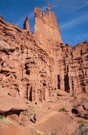 Woman hiking by Fishers Tower in Moab, Utah, USA