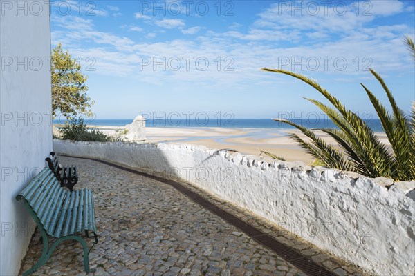 Benches on footpath by beach in Cacela, Portugal