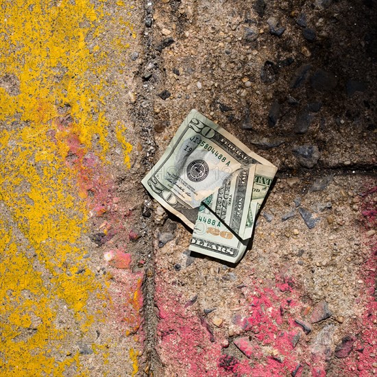 Crumpled money on sidewalk