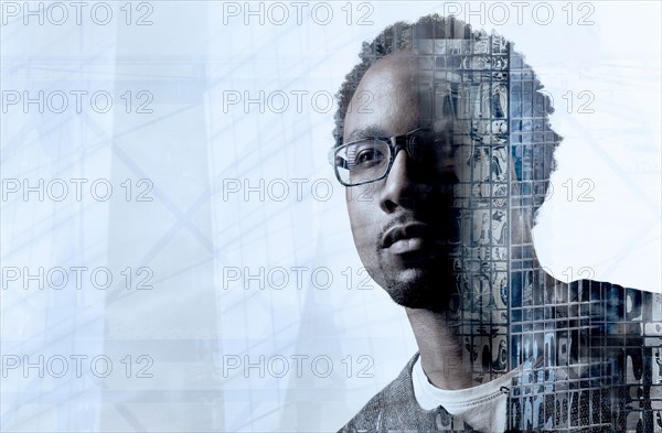 Double exposure of young man and skyscraper