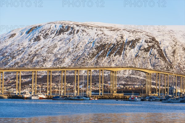 Bridge by snow covered hill in Tromso, Norway