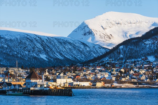 Town under snow covered mountains in Tromso, Norway