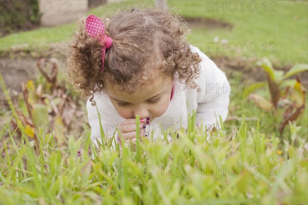 Girl smelling flower